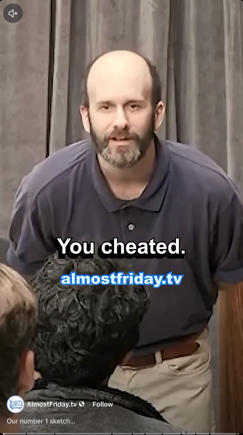 AlmostFriday.tv video still showing a man saying “You cheated” to someone seated in front of him.