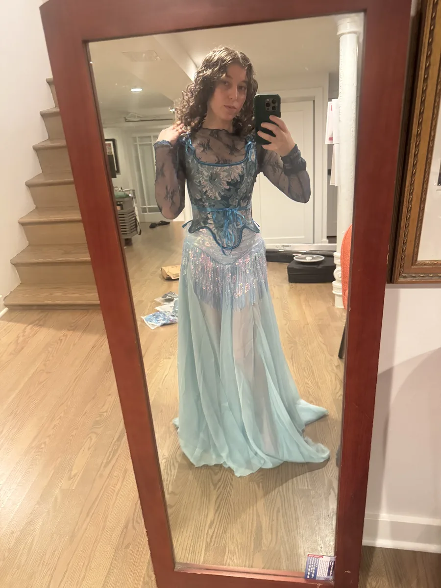 Try-on photo of a blue outfit in a mirror