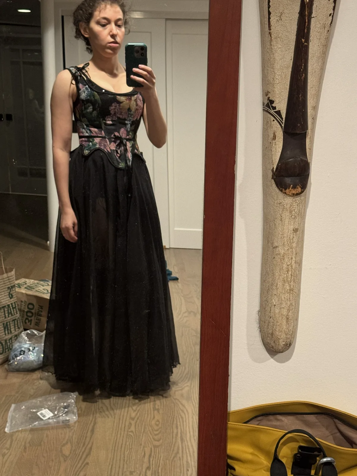 Mirror selfie wearing a floral black corset with a full-length black tulle skirt.