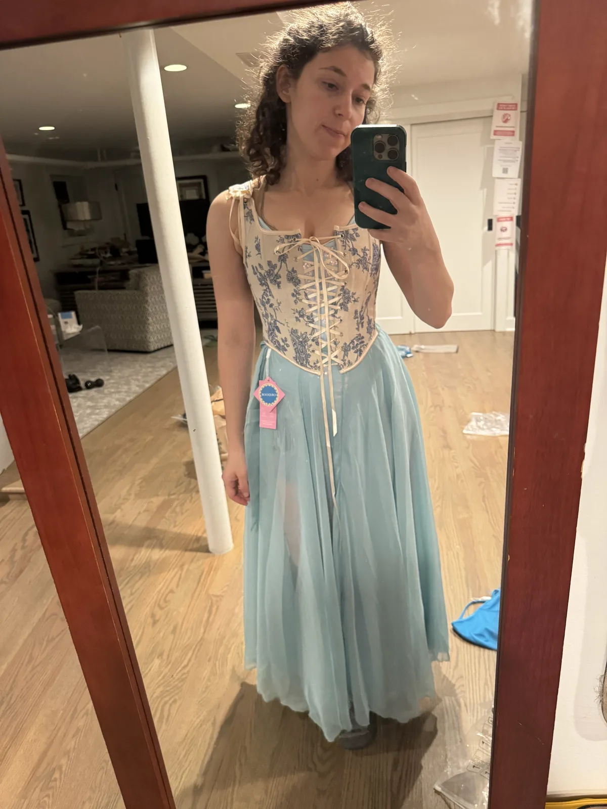 Mirror selfie wearing a pale blue corset with a full light blue skirt.
