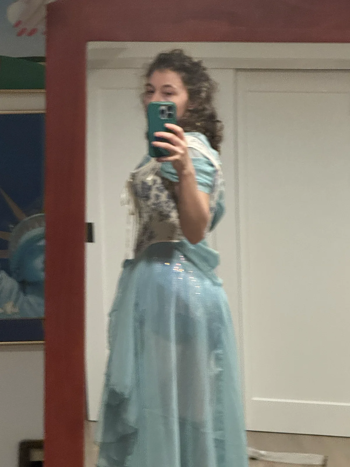 Mirror selfie wearing a pale blue corset with a layered light blue skirt.